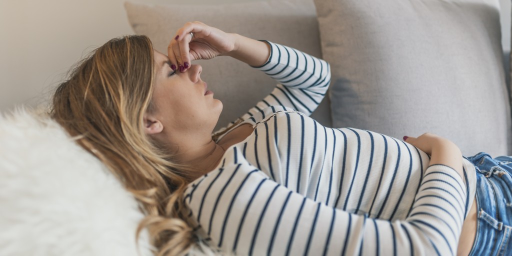 woman lays back on couch trying to control her cravings
