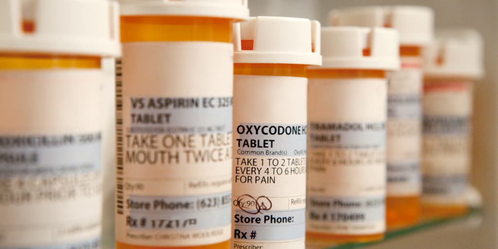 bottles full of commonly abused prescription drugs oxycodone in focus