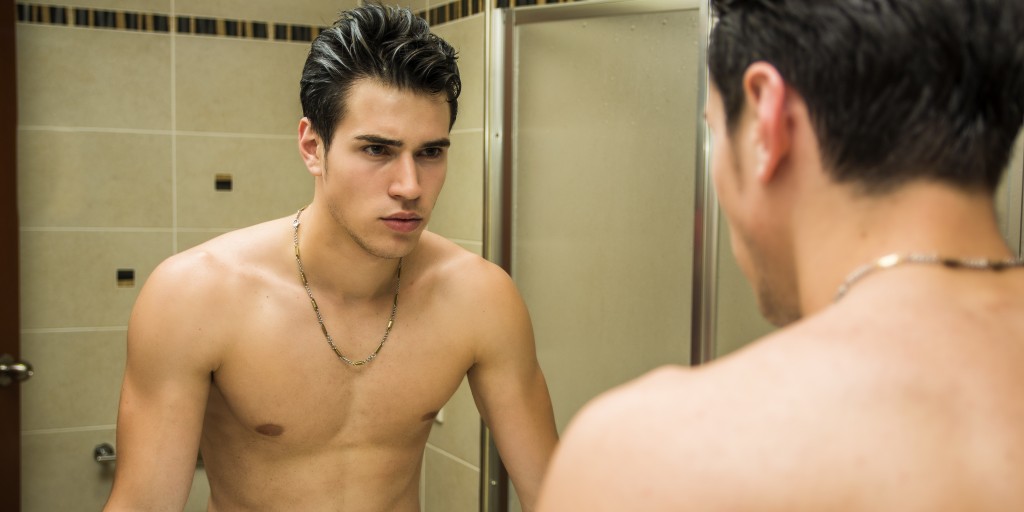 man looking at himself in the mirror wondering if he has an addictive personality
